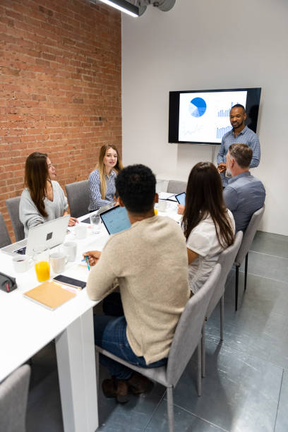 istock Businessman giving presentation with colleagues 1266475753