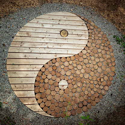 wooden Yin and yang on a path