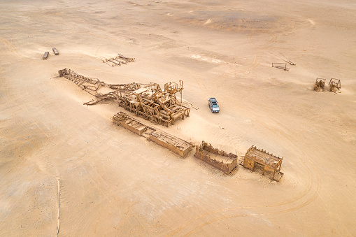 Collapsed Oil Drill Tower Rig, Skeleton Coast, Namibia. Car has been redesigned in Photoshop. Important aspect of the picture to see the scale.