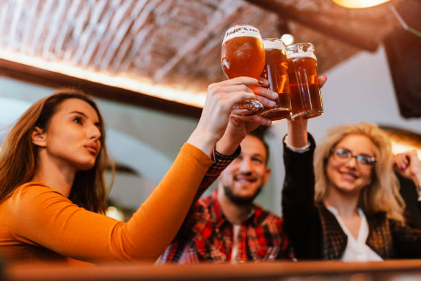 istock Cheers celebration toast with pints of beer 1266476563