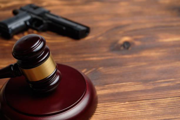 istock The combat pistol next to the judge hammer. 1266477696