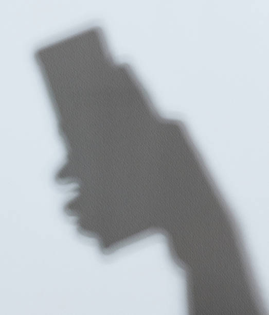 istock Shadow of hand holding smartphone 1266481130
