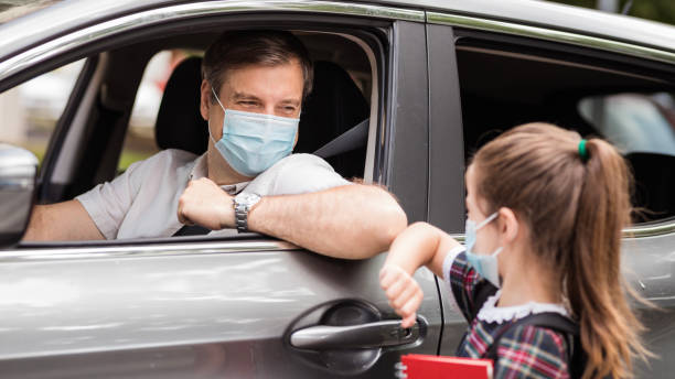 istock Father and daughter wearing masks and having an elbow greeting 1266484826