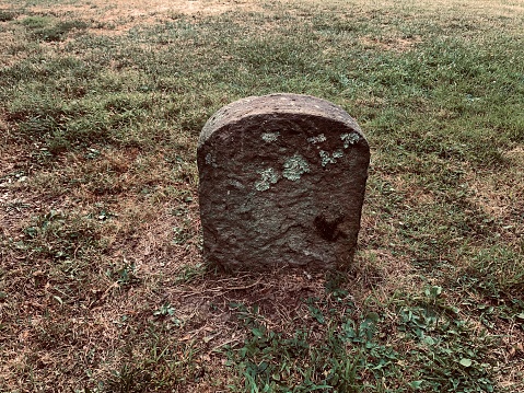 Old headstone in grass