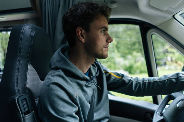 istock Young man drives motor home through national park 1266484963