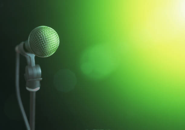 vocal dynamic microphone lit by stage spotlight awaits performer or speaker - brightly lit audio imagens e fotografias de stock