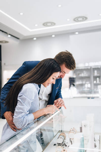 istock Middle age couple in jewelry store 1266487233