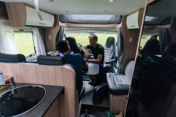 istock Young men work together on their laptop from a motor home 1266487430