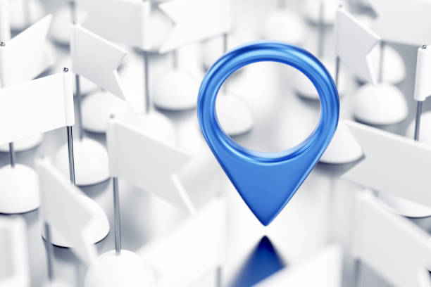 Blue colored location pointer in surrounding of identical white pennants which are randomly arranged on reflective white surface. 3D rendering graphics on the theme of GPS Technology.