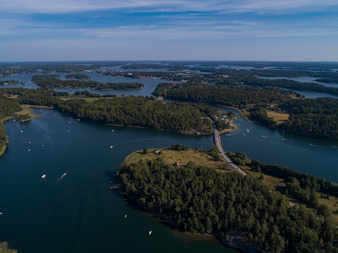 Aerial view over Stockholm archipelago. Several boats near island.