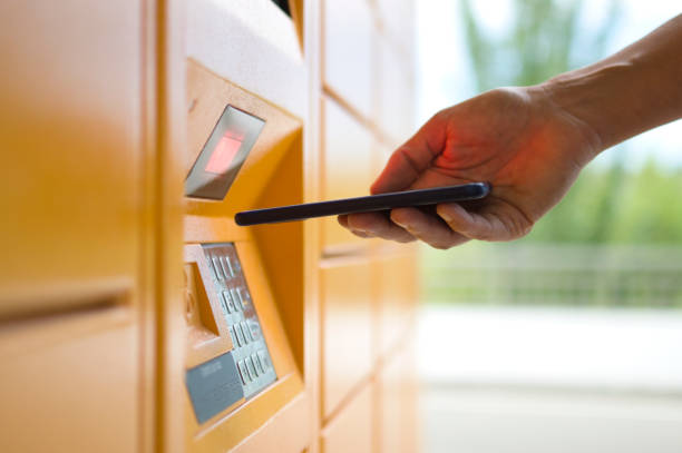 istock woman picking up a package from an automated locker 1266495920