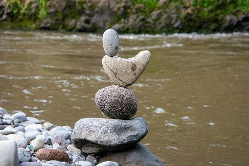 Balancing stones in a river, art in nature, meditation and yoga for the human body