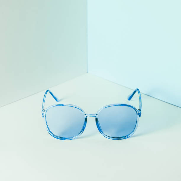 istock Stylish blue sunglasses on modern minimal pastel background, front view. Nobody. Product photograph 1266499440