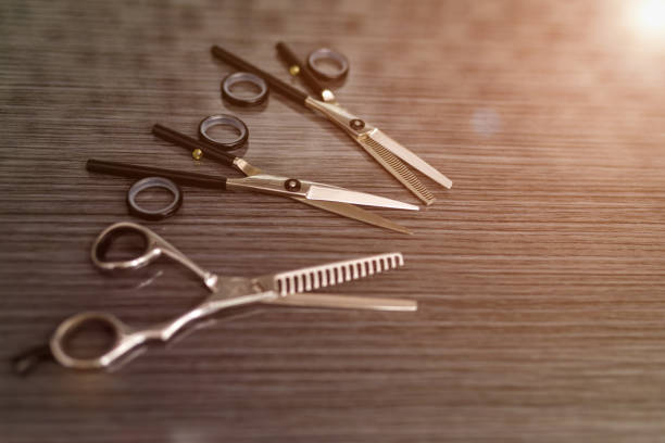 istock Hairdressing different scissors on table in professional hairdressing salon. 1266500471