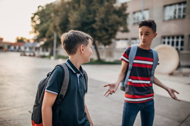 istock Two schoolboys going to school together 1266505958