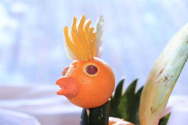Carved fruit bird Carved fruit bird on display at a cruise ship buffet fruit carving stock pictures, royalty-free photos & images