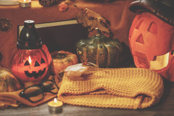 istock Cut out of lit jack-o'-lanterns surrounded by colorful decorations 1266509654