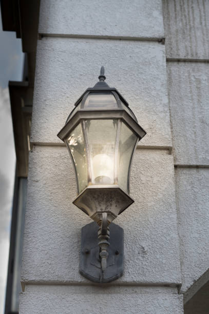 istock Western lantern lamp on stone wall. 1266509844