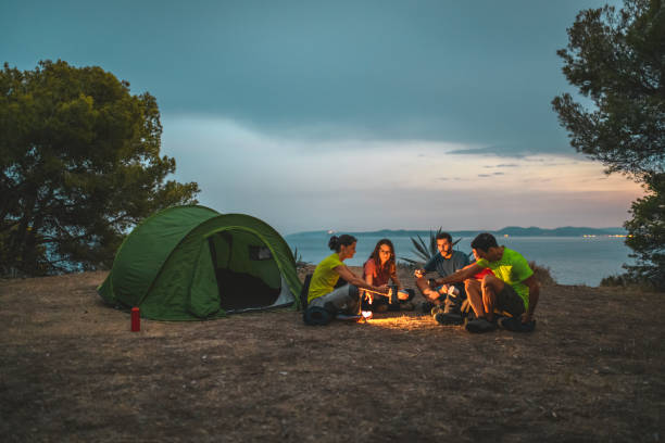 istock Spanish Friends Camping on Mediterranean Coast at Sunset 1266510046