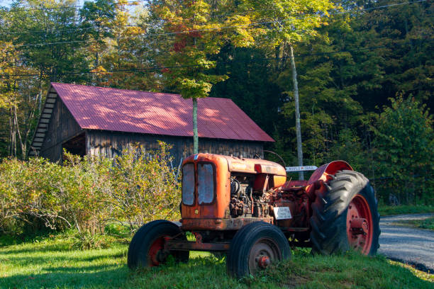istock Vintage tractor in front  of an old barn 1266514236