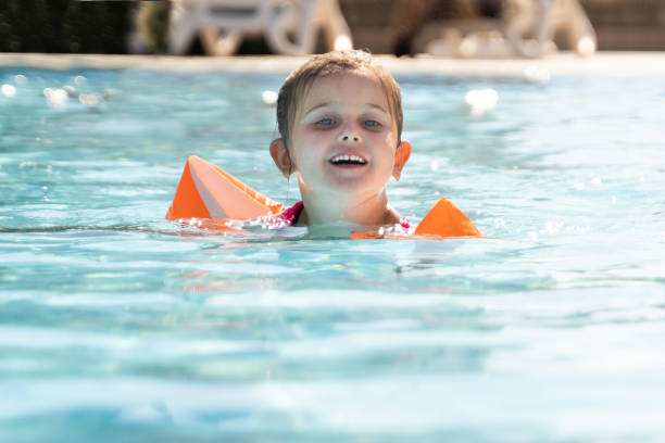 istock Child Girl In Swimming Pool Playing 1266532256