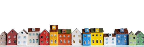 Row of wooden miniature colorful retro houses on white background Colorful miniature houses arranged in a row on white background. Urban city background banner. Copy space row house photos stock pictures, royalty-free photos & images
