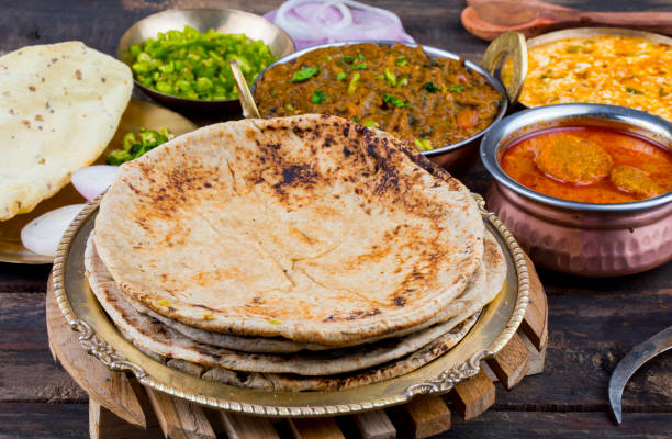 Indian Cuisine Chapati with Sev Tamatar, Gatta Curry, Raita, Papad or Onion on Wooden Background Indian Cuisine Chapati Also Called Roti, Flatbread, Chapathi or Chapatti Served With Sev Tamatar, Gatta Curry, Raita, Papad or Onion on Wooden Background taftan stock pictures, royalty-free photos & images