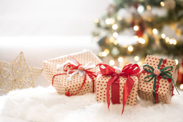 istock New year holiday background with a gift box in a cozy atmosphere. 1266541371