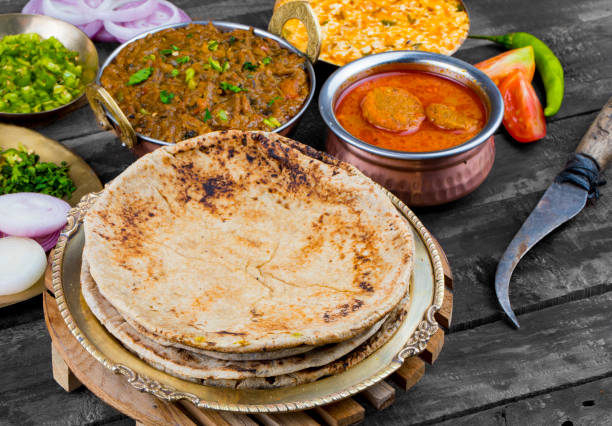 Indian Cuisine Chapati with Sev Tamatar, Gatta Curry, Raita, Papad or Onion on Wooden Background Indian Cuisine Chapati Also Called Roti, Flatbread, Chapathi or Chapatti Served With Sev Tamatar, Gatta Curry, Raita, Papad or Onion on Wooden Background taftan stock pictures, royalty-free photos & images