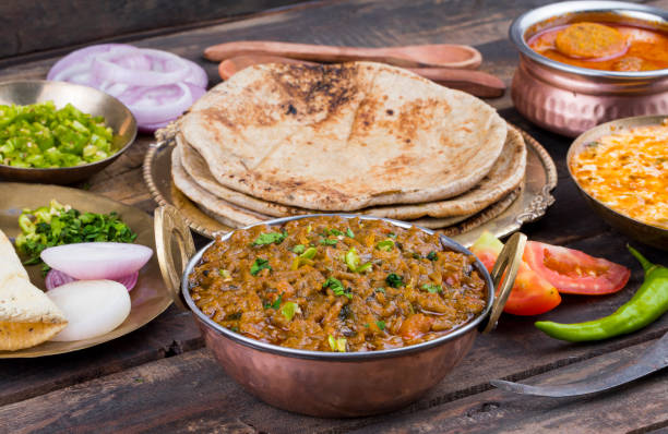istock Indian Cuisine Sev Tamatar on Wooden Table 1266543661