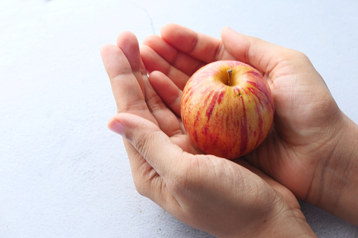 Close up of fresh apple on women hand