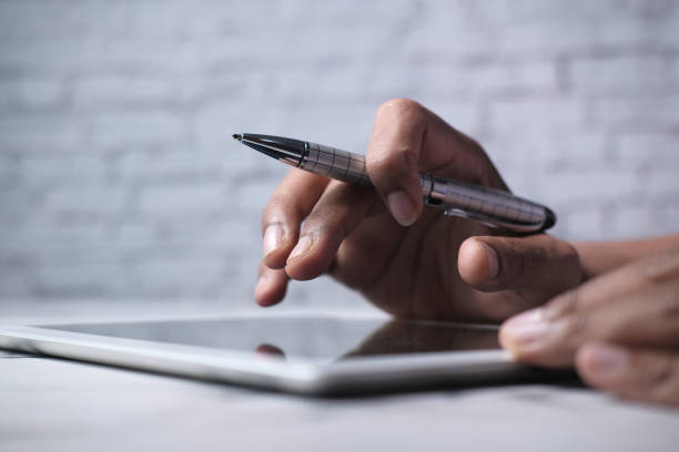 istock man's hand working on digital tablet at office desk, 1266545893