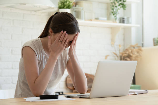 istock Tired overworked female freelancer hiding face in palms 1266551932