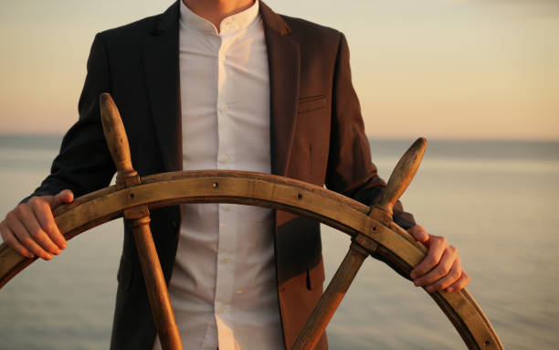 istock Businessman holding ship wheel and navigates. 1266553944