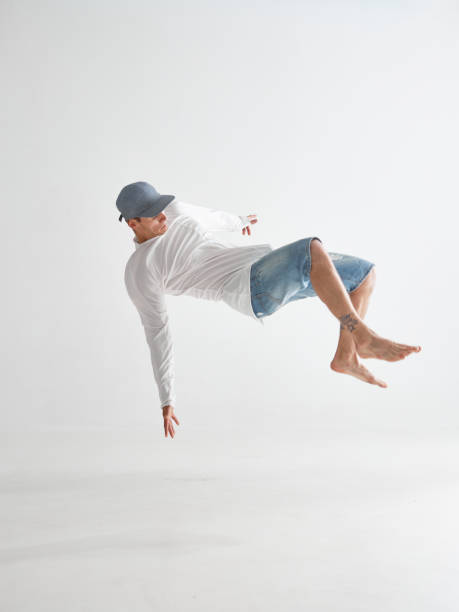 Cool stylish guy dancer levitating isolated on white background. Dance school poster. Photography for app or ad
