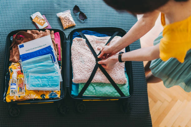 istock Suitcase packing for travel, COVID-19 1266556611