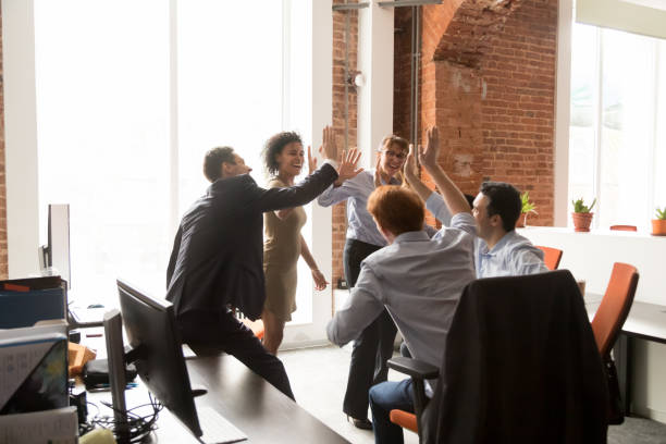 istock Happy excited diverse employees giving high five at briefing 1266558141
