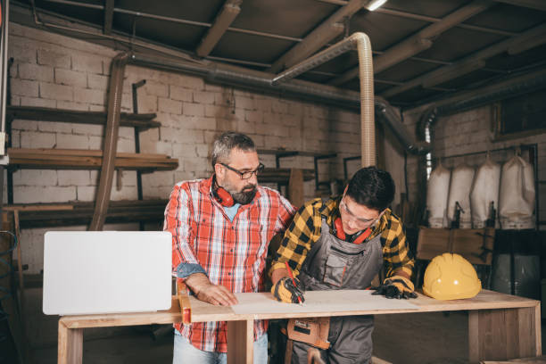 istock Father and son working in carpenter shop 1266560370