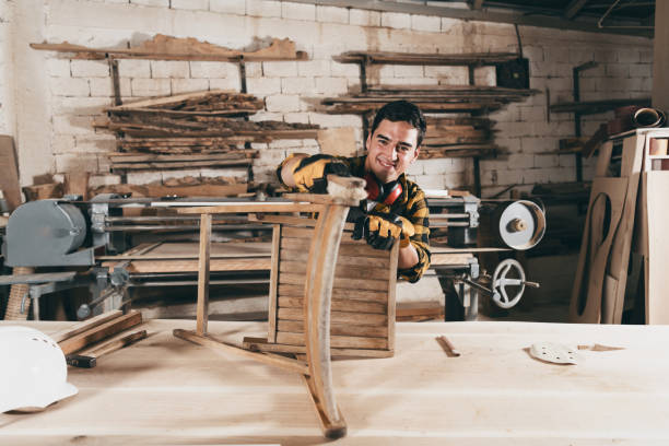 Professional male carpenter repairing antique furniture in workshop, varnishing vintage chair Professional carpenter engaged in restoring antique furniture using instruments carpenter carpentry craftsperson carving stock pictures, royalty-free photos & images