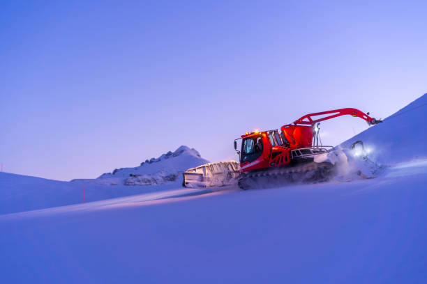 Wengen Switzerland, Switzerland – January 11, 2024: A Pistenbully grooming slopes on a sunny day in Switzerland, Bernese Oberland