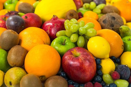 many fruits food background theme with lots of colorful organic food representing vitamins and minerals vegan living