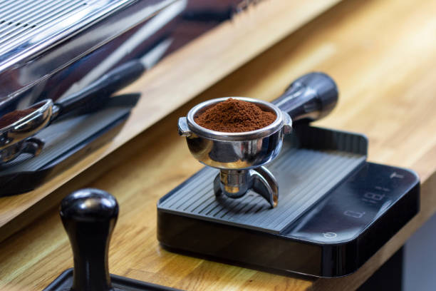 portafilter with freshly ground morning coffee on the scales - tamper imagens e fotografias de stock