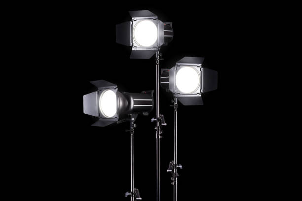istock Photography studio flash on a lighting stand isolated on black background. 1266565683