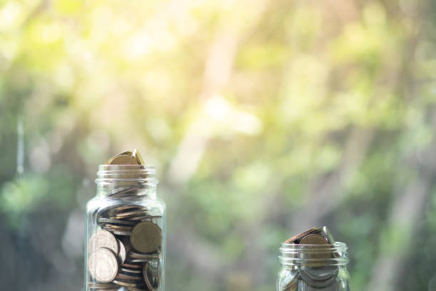 istock Full coin in two glass bottle with copy space for your text 1266569493