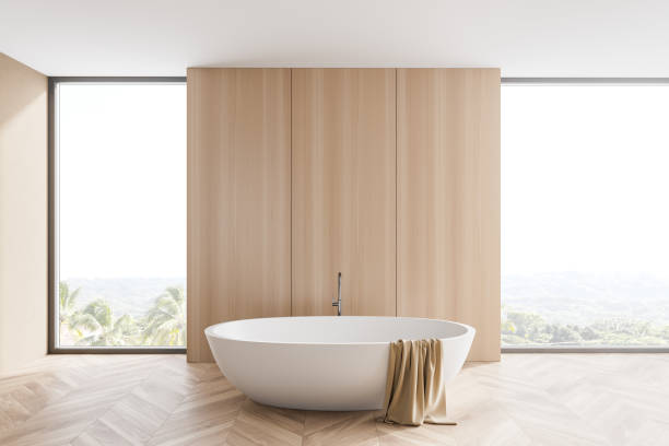 istock Wooden bathroom interior with tub and windows 1266570312