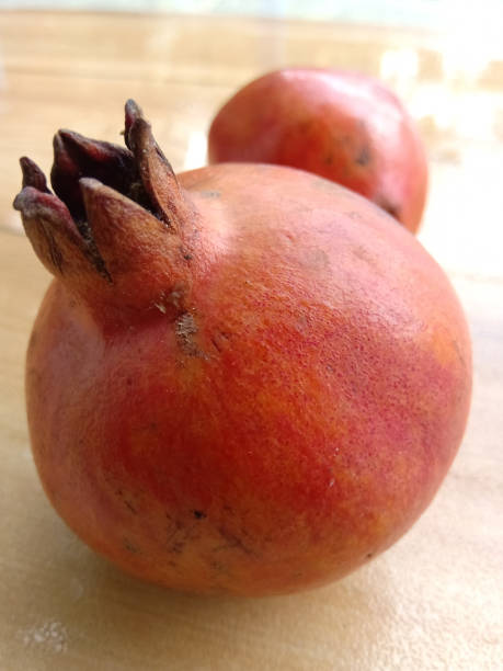 istock Two pomegranates placed together,one behind the other. 1266572570