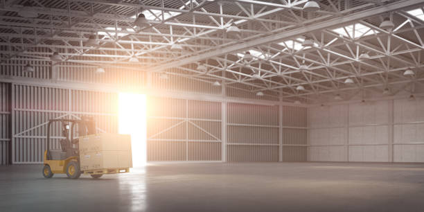 istock Empty warehouse or storehouse with forklift and sunlight in open gate. 1266578085
