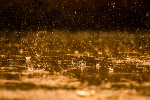 istock Close up of raindrops falling on a surface 1266579130