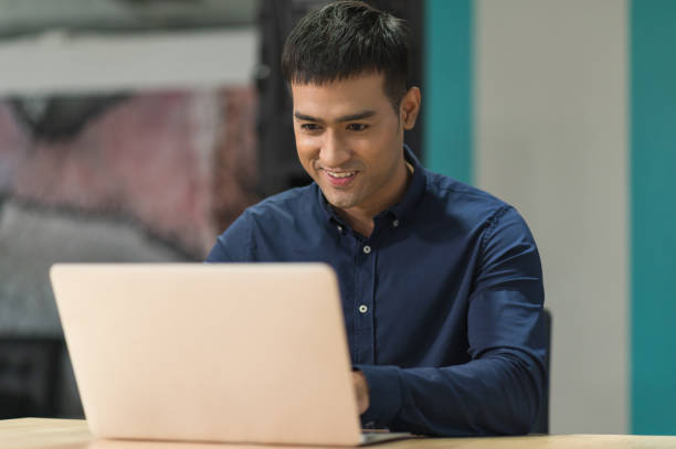 istock Young asian businessman working with laptop in office. 1266580817