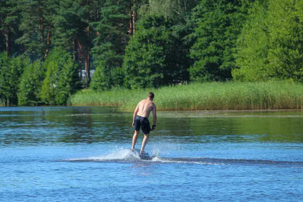 A man rides a hydrofoil on the lake